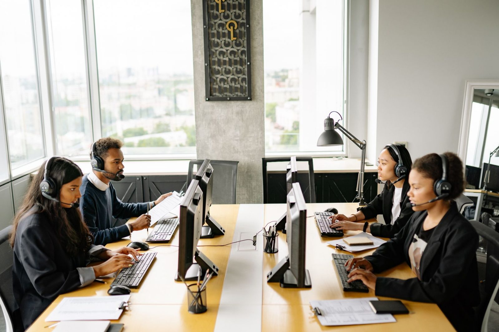 Colleagues at a shared desk in a bright office