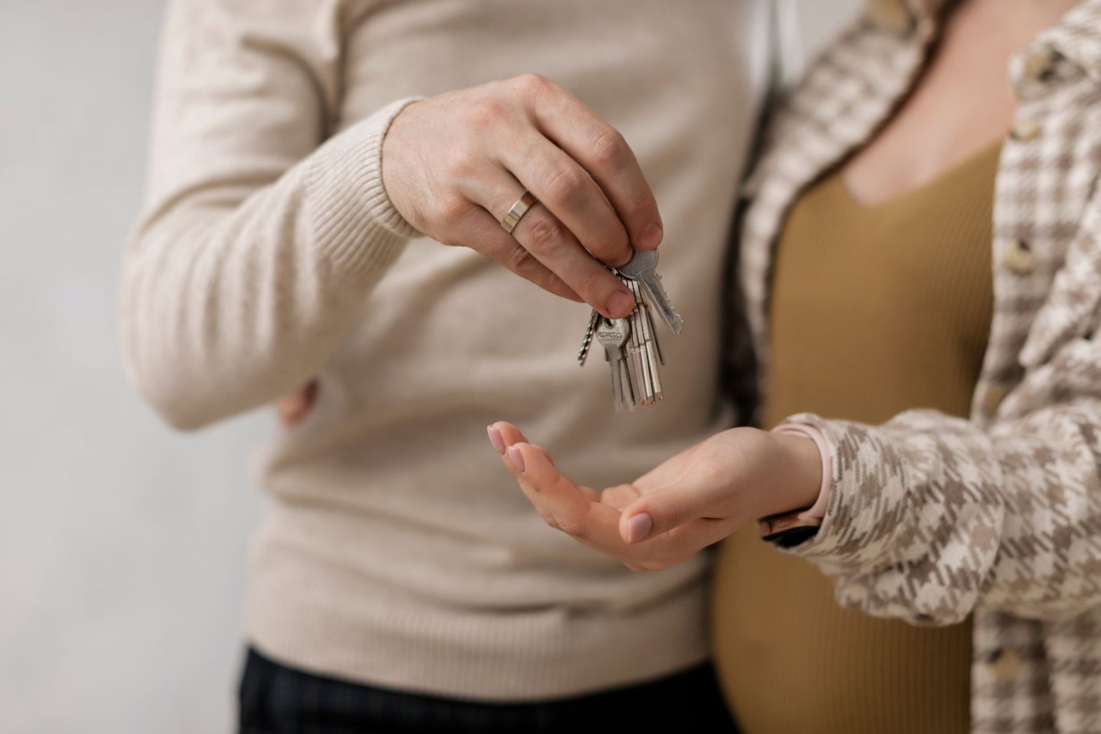 A set of keys being handed from one person to another