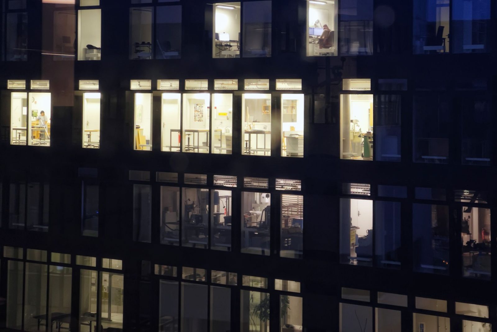An office building at night with the windows still lit