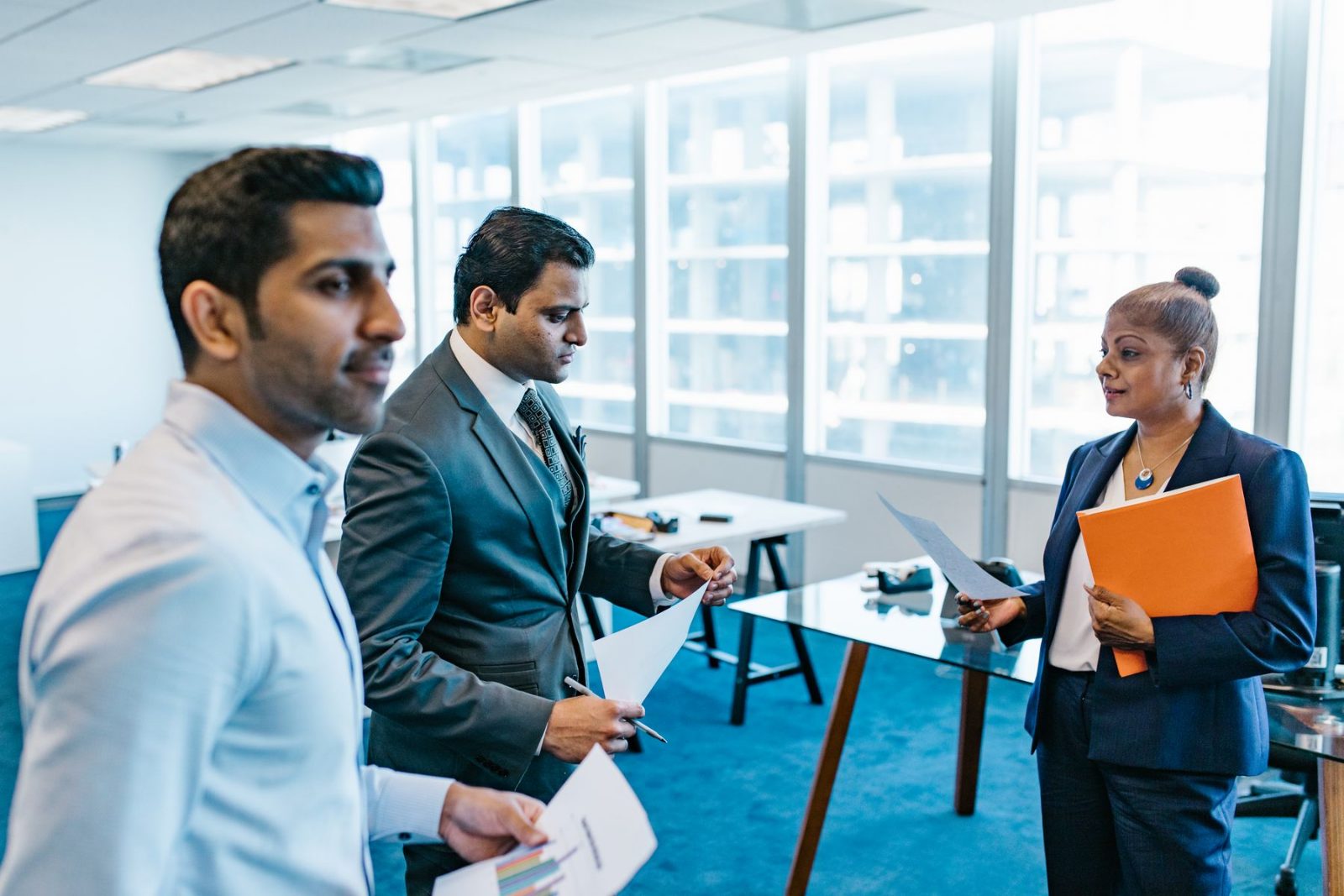 Colleagues talking through a document at a table