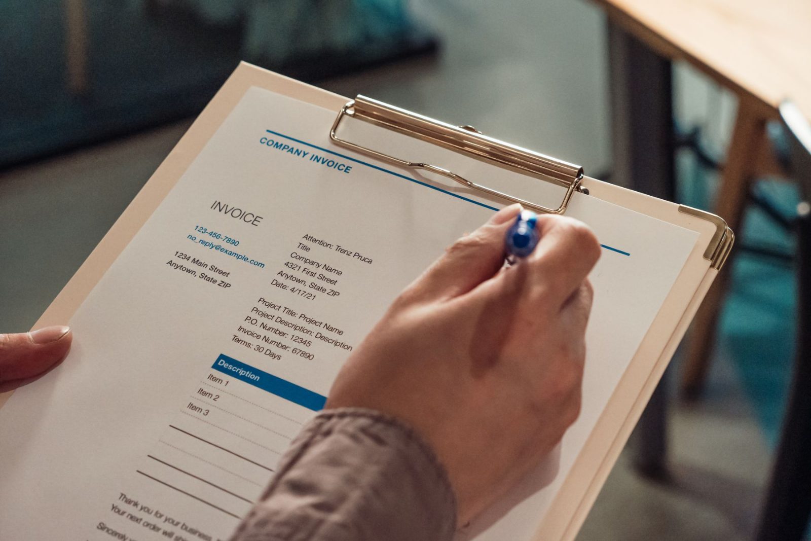 Invoices being checked off against a clipboard