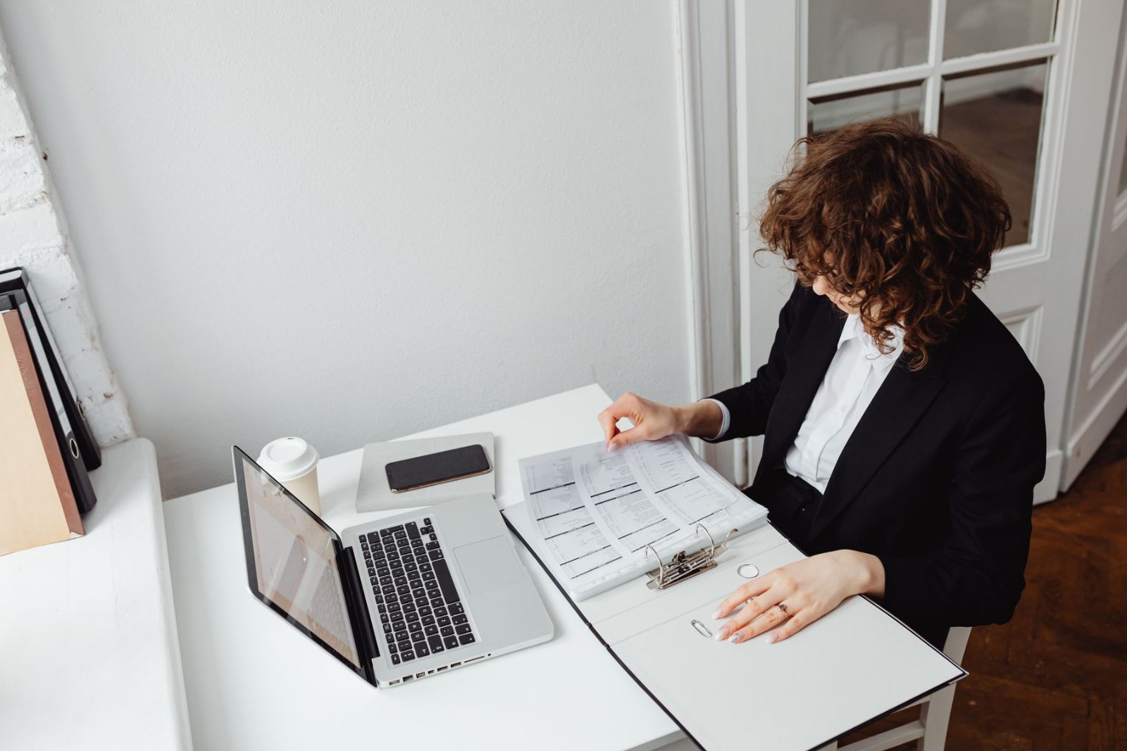 An administrator working through a planner at a desk