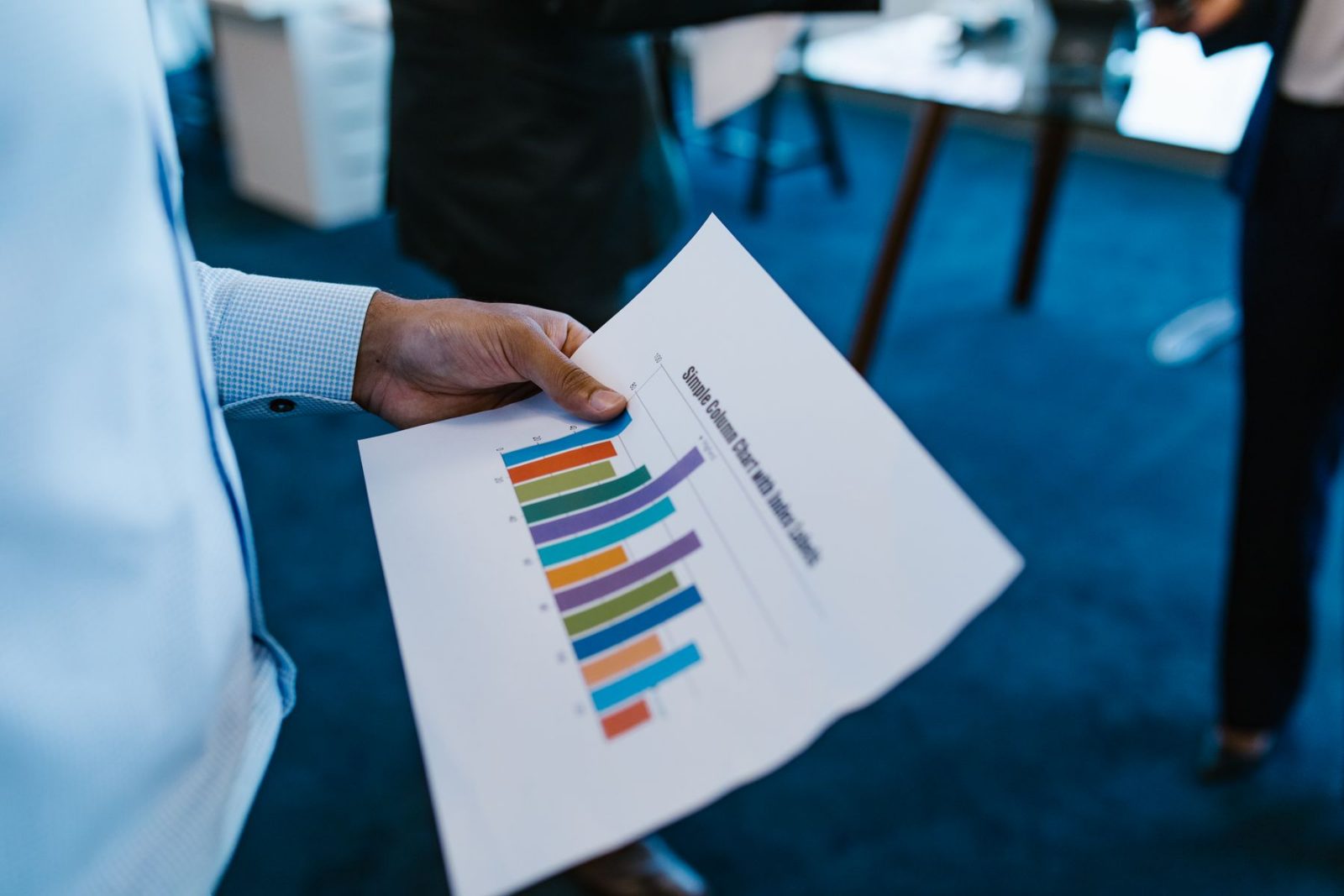 Two colleagues reconciling a financial report together