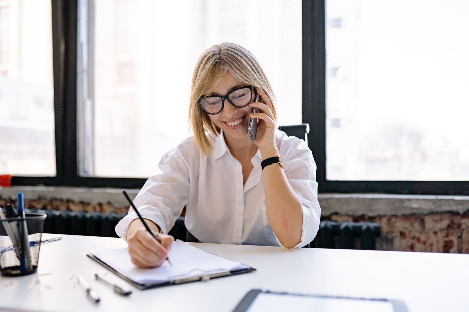 A business development representative on a call at a desk