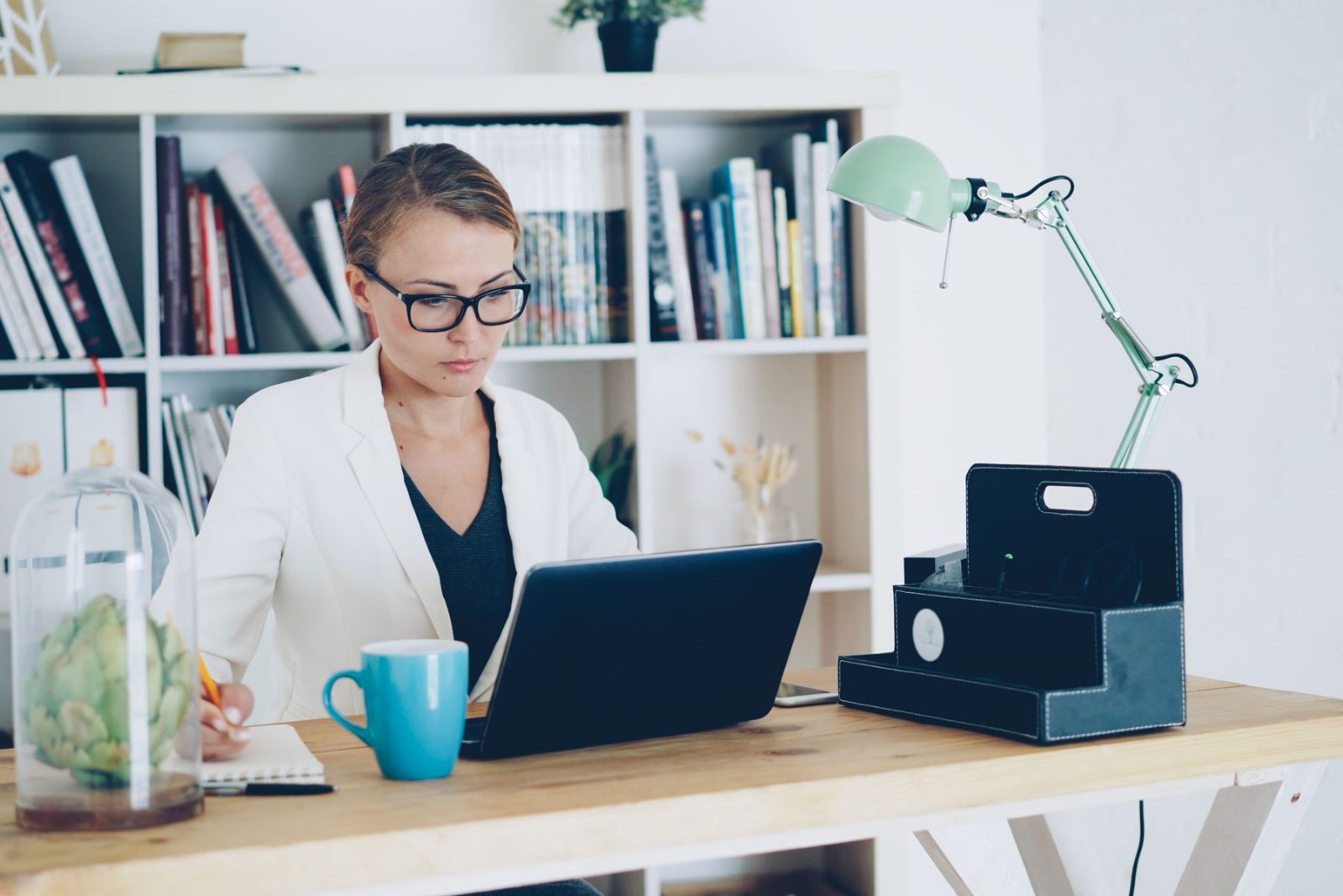 An executive assistant working at an organised desk