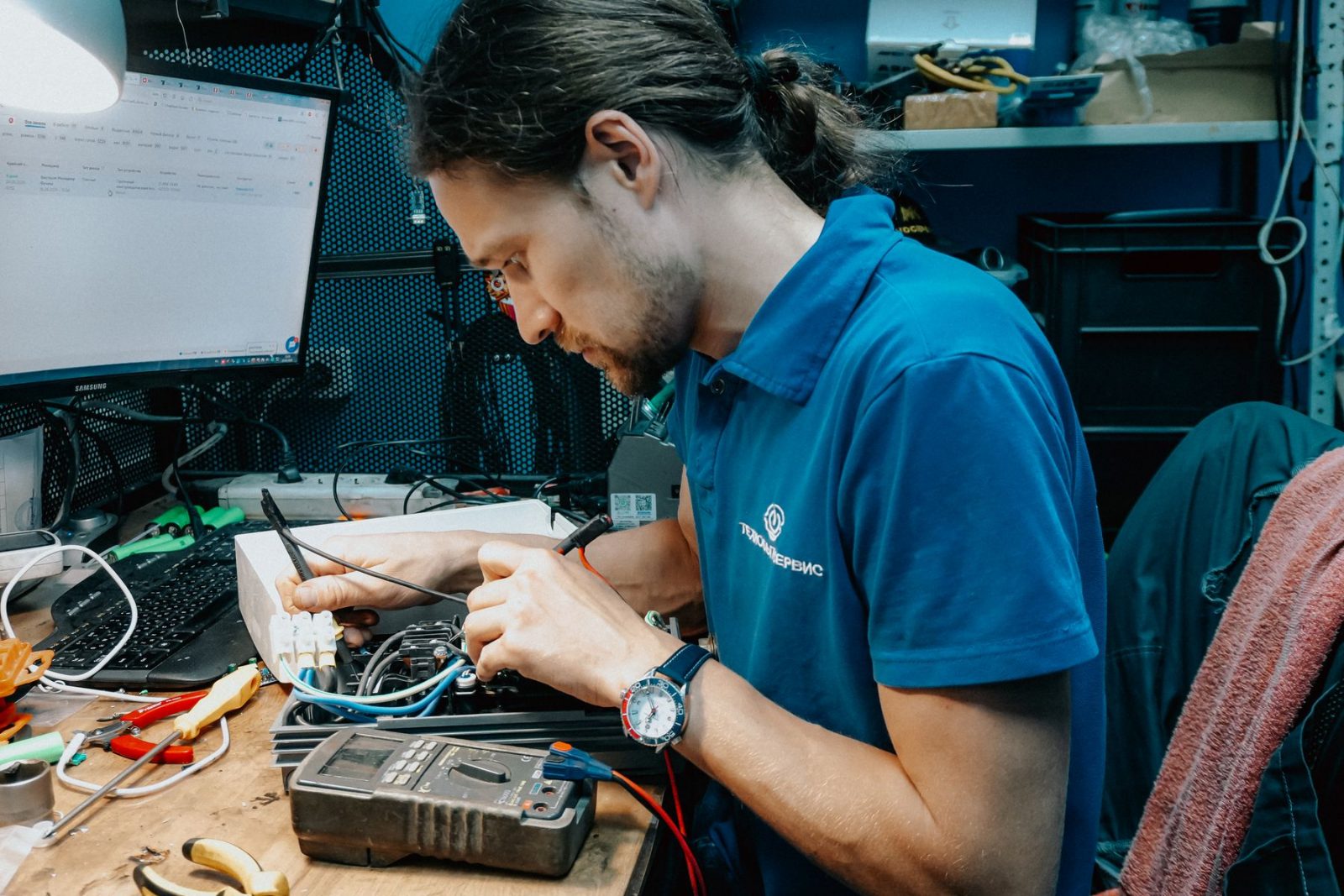 An IT specialist working on network equipment