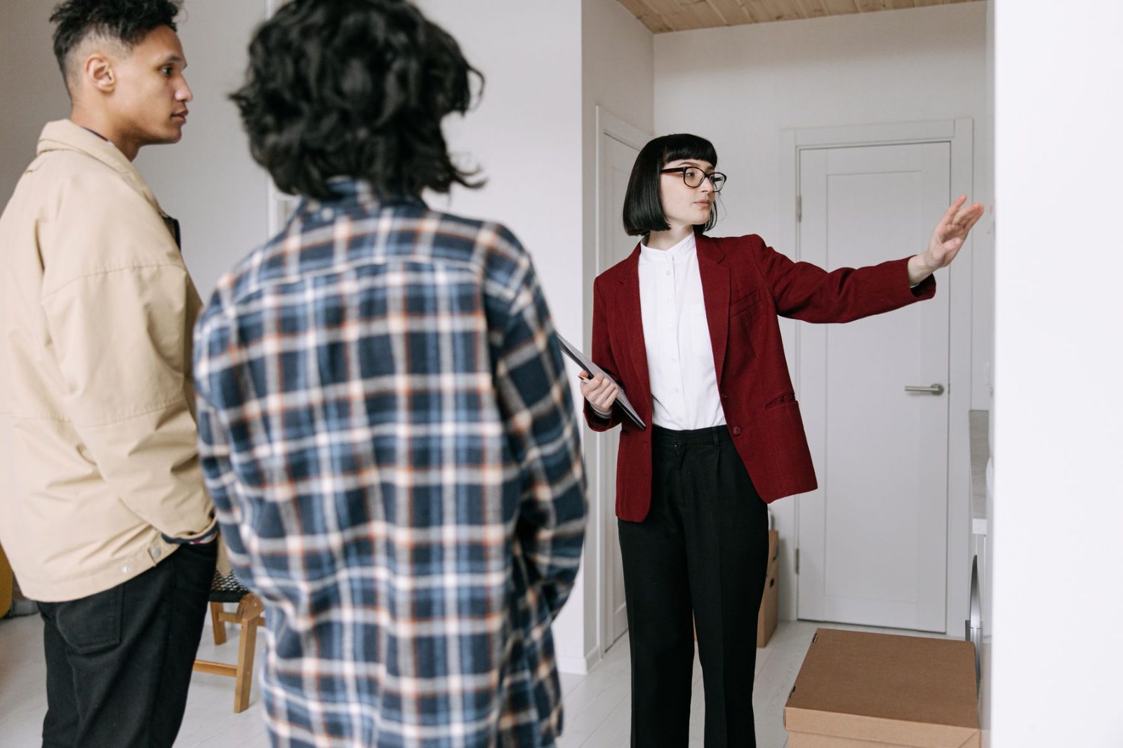 An agent showing an empty apartment to prospective renters