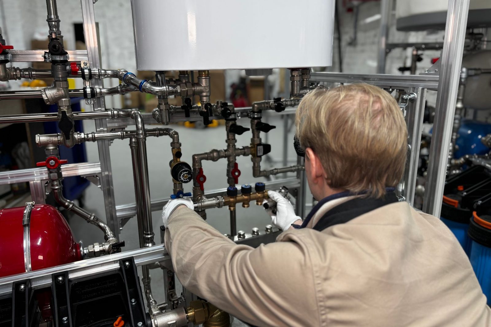 A technician checking building plant equipment
