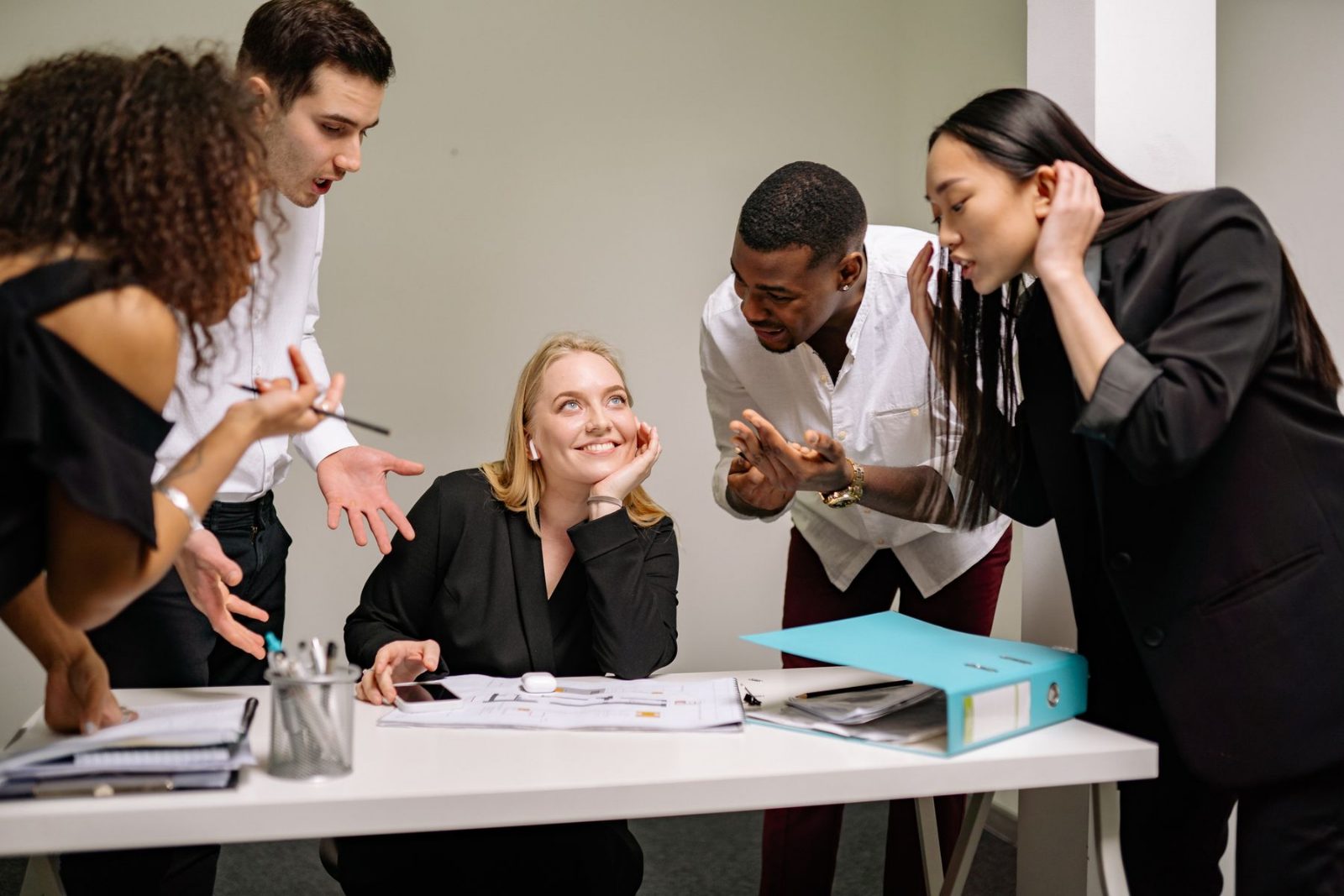 A team reviewing work together around a table